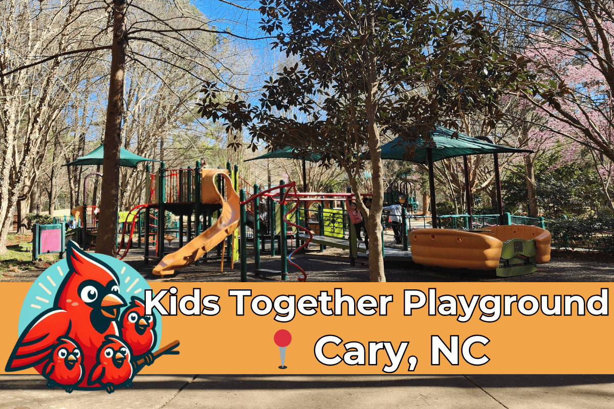 The vibrant Kids Together Playground in Cary, NC, on a sunny day, featuring colorful play structures such as slides and swings, with children actively playing. The Raleigh Family Adventure logo with cheerful red birds is prominently displayed in the foreground, enhancing the family-friendly atmosphere of the park.